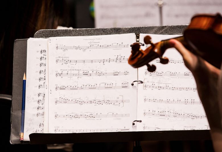 A violinist practices as the SYSO prepares for the opening of its season on Nov. 15 with Johannes Brahms’s Symphony No. 4, along with Glinka’s “Russlan und Ludmilla” overture and Barber’s Violin Concerto, Op. 14. (Lindsey Wasson/The Seattle Times)