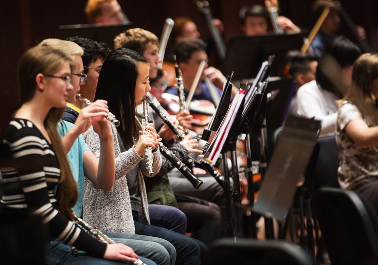 Flutists chime in during Samuel Barber’s Violin Concerto, Op. 14 during a Seattle Youth Symphony Orchestra dress rehearsal at Benaroya Hall. (Lindsey Wasson/The Seattle Times)