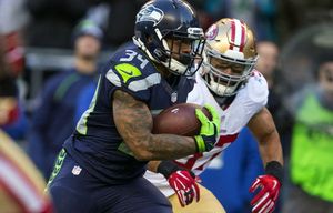 Seahawks running back Thomas Rawls shakes off 49ers linebacker Michael Wilhoite on his way to a touchdown in the fourth quarter at CenturyLink Field Sunday, Nov. 22, 2015.