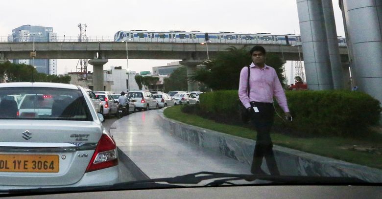 It takes 45 minutes for this traffic to exit Cyber City in the evening commute in Gurgaon, India. A modern light-rail system is being extended and will eventually help those willing to take mass transit.  (Alan Berner / The Seattle Times)