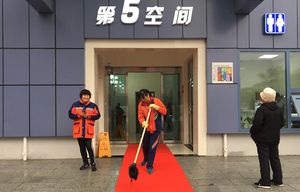 Workers prepare the red carpet for the rollout of the new “5th Space” public restroom in Beijing on Thursday, which also happened to be World Toilet Day.  (Julie Makinen/TNS)