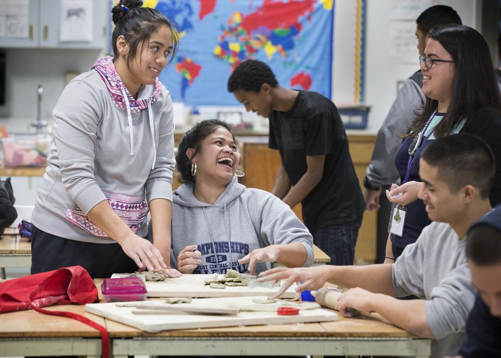 Making gifts out of clay during a Pacific Islander Club gathering after school are, from left, Reyleen Gogo, and Veronica Ioane (center laughing). At right (with glasses) is art teacher Christina Busby. (Mike Siegel/The Seattle Times)