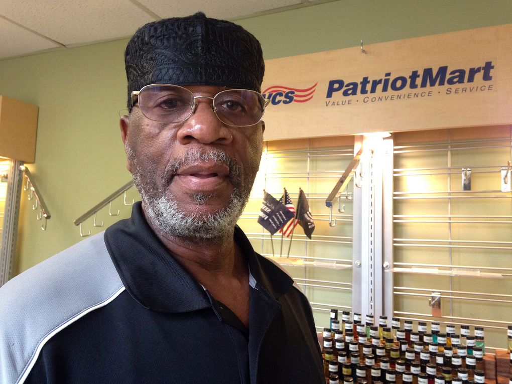 Abdul Karim Ali stands in front of his natural body care products booth at the CW Bill Young VA Medical Center in St. Petersburg, Fla., on Wednesday, Dec. 9, 2015. Ali became a Muslim in 1975 and says the religion has inspired him to serve his community in various ways, including participation in an interfaith council, local politics and a neighborhood watch group. (Tamara Lush / The Associated Press)