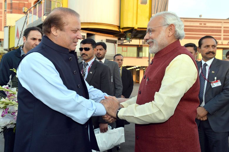 epaselect epa05080693 A handout photograph released by the Indian Press Information Bureau (PIB) on 25 December 2015 of Indian Prime Minister Narendra Modi (R) being welcomed by the Prime Minister of Pakistan, Nawaz Sharif (L), at the airport in Lahore, Pakistan, 25 December 2015. Modi arrived in Lahore on a surprise stopover 25 December in the first visit by an Indian prime minister to Pakistan since 2004. India and Pakistan have had troubled ties in past decades over border disputes and terrorism accusations. The South Asian neighbours this month agreed to resume stalled peace talks.  EPA/PRESS INFORMATION BUREAU/HANDOUT  HANDOUT EDITORIAL USE ONLY/NO SALES
