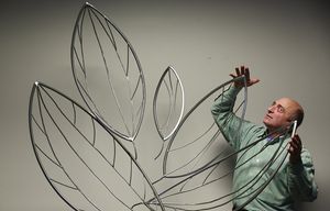 Artist Dennis Warshal is photographed with his steel sculptures in Seattle Monday, Dec. 7, 2015. Warshal will be showcasing his sculptures at the pop-up gallery “Leaves of Change” until January 12, 2015 at 1201 Second Avenue in downtown Seattle.