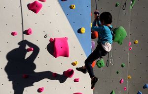 A young climber works his way up an outdoor climbing wall at Stone Gardens, 2839 NW Market St., near the Ballard Locks.