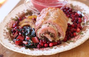 This Nov. 2, 2015 photo shows stuffed pork loin with cranberry beurre blanc in Concord, N.H. It is filled with a blend of bacon, onions, fresh sage and rosemary, and some crunchy panko breadcrumbs. (AP Photo/Matthew Mead) NHMM