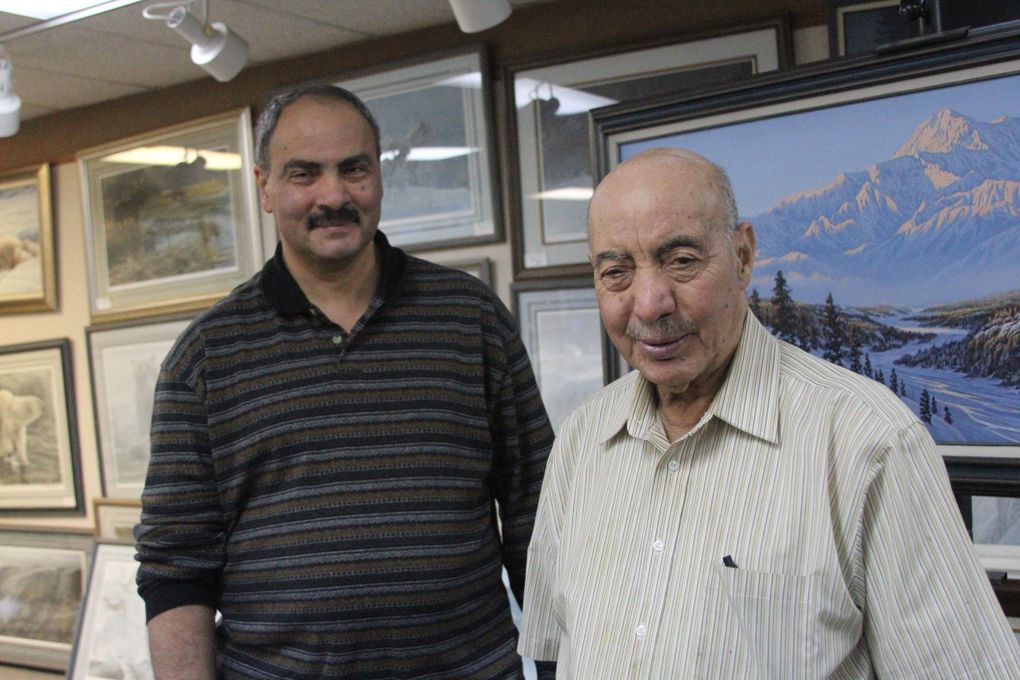 In this Tuesday, Dec. 8, 2015 photo, Sam Obeidi, 58, left, and Mousa Obeidi, 90, pose for a photo in their art gallery in Anchorage, Alaska. Mousa says he was the first Muslim in Alaska when he arrived in 1964, and his son, Sam, helps new immigrants to Anchorage integrate into the American way of of life. (Mark Thiessen / The Associated Press)