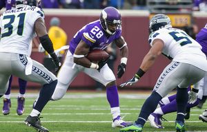 Vikings running back Adrian Peterson is wrapped up in the first quarter by Seahawks safety Kam Chancellor and linebacker Bobby Wagner as the Seattle Seahawks defeated the Minnesota Vikings 38-7 at the TCF Bank Stadium in Minneapolis Sunday December 6, 2015. Peterson was held for just 18 yards on 8 carries.
