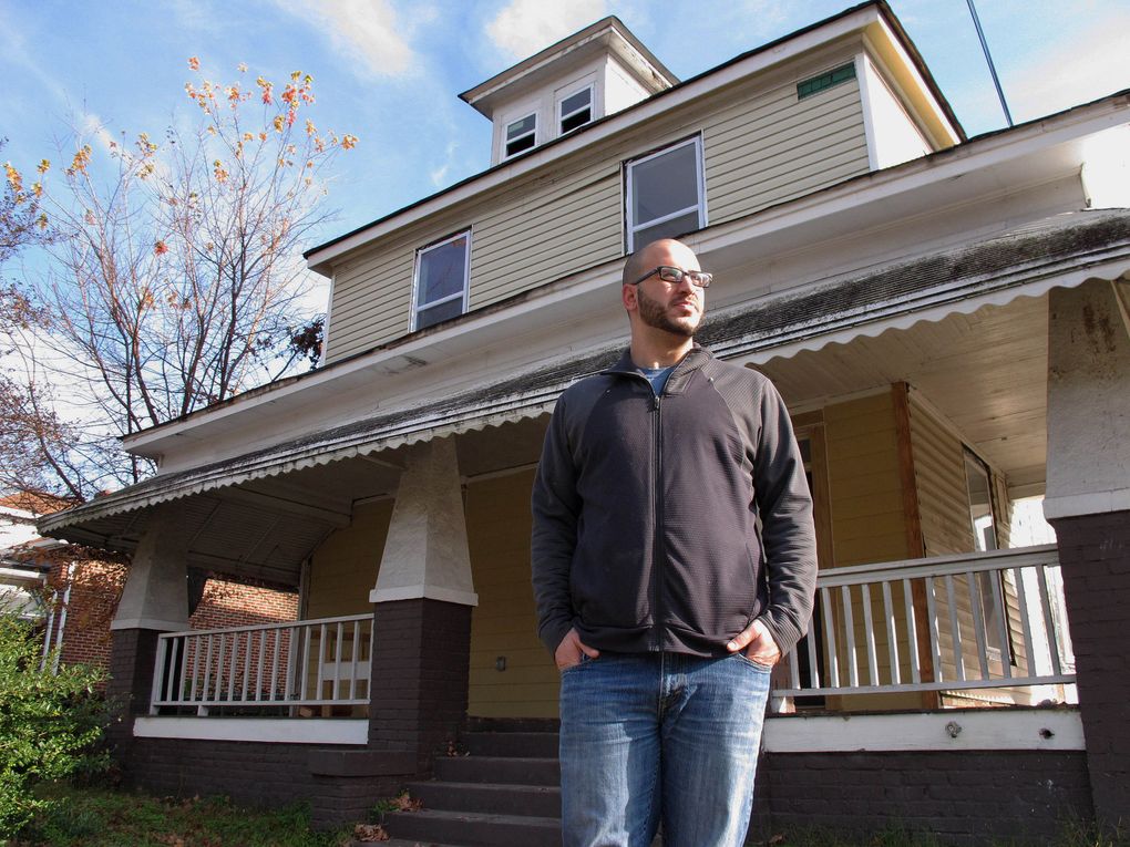 Farris Barakat stands in front of the Light House in downtown Raleigh, N.C., on Wednesday, Dec. 9, 2015. The house belonged to his brother, Deah, who was gunned down in February along with his wife and her sister. This act of brutality set the older brother on a new path. He left his job as a business manager with a local courier service and began renovating the property his brother owned. “Our community _ our Muslim community _ doesn’t really do too much … outreach work” _ and that will be part of the Light House’s aim, says Barakat, whose parents are from Syria but who was born in Raleigh. (Allen G. Breed / The Associated Press)