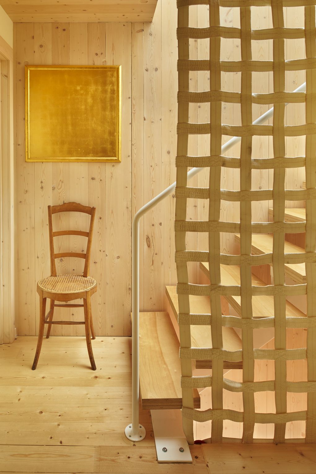 Light pours down the second-floor birch ply stair treads from an overhead Solar Innovations skyhatch that leads to a rooftop deck and garden. (Benjamin Benschneider/The Seattle Times)
