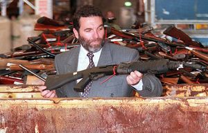 TO GO WITH US-shooting-guns-Australia,FOCUS by Martin Parry
(FILES) This file photo taken on July 28, 1997 shows a policeman responsible for the collection of guns, Mick Reolandts, holding a military type shotgun, one of 4,500 guns on display before being melted down in Sydney after Australia banned all automatic and semi-automatic rifles in the aftermath of the Port Arthur shooting in 1996. When Martin Bryant massacred 35 people with semi-automatic weapons at Port Arthur in 1996, then-Australian prime minister John Howard reacted swiftly by pushing for tough new national gun laws. Within a year gun licences had been tightened, a weapons buy-back was enacted and an amnesty launched for anyone holding illegal arms, moves that took more than 600,000 guns out of action. AFP PHOTO / FILES / WILLIAM WEST (Photo credit should read WILLIAM WEST/AFP/Getty Images)