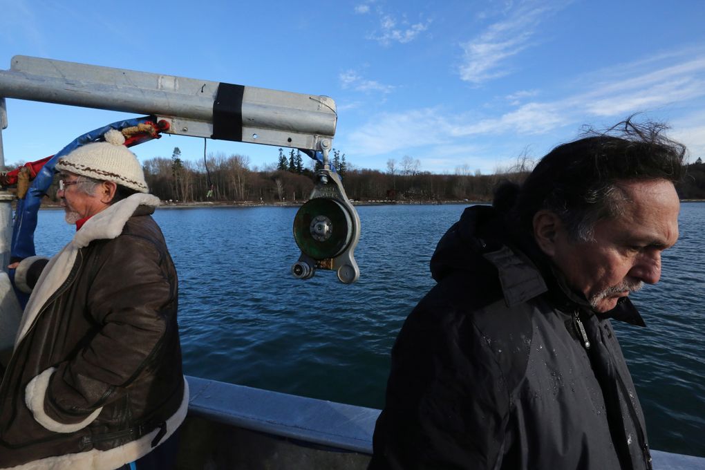 Lummi tribal members Al Scott Johnnie, left, and Jewell Praying Wolf James aboard the Golden Eagle crab boat with Cherry Point in the background. (Alan Berner/The Seattle Times)