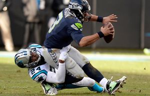 Carolina Panthers’ Josh Norman (24) sacks Seattle Seahawks quarterback Russell Wilson (3) during the third quarter on Sunday, Jan. 17, 2016, at Bank of America Stadium in Charlotte, N.C. (David T. Foster III/Charlotte Observer/TNS)