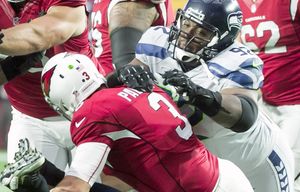 Seahawks defensive lineman Brandon Mebane and Seahawks defensive lineman Michael Bennett pressure Cardinals quarterback Carson Palmer to throw incomplete in the first quarter as the Seattle Seahawks defeated the Arizona Cardinals 36-6 Sunday January 3, 2016 at University of Phoenix Stadium in Glendale.