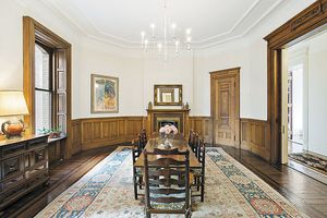 Pocket doors, wainscoting and a corner china cabinet are among details in the dining room. (Tribune News Service)