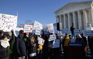 People participate in a rally at the Supreme Court in Washington, Monday, Jan. 11, 2016, as the court heard arguments in the ‘Friedrichs v. California Teachers Association’ case. The justices were to hear arguments in a case that challenges the right of public-employee unions to collect fees from teachers, firefighters and other state and local government workers who choose not to become members.  (AP Photo/Jacquelyn Martin) DCJM102
