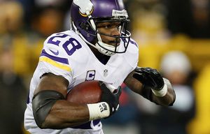 Adrian Peterson, running back for the Minnesota Vikings and National  Football Conference (NFC) all-star team, splits defenders during the NFL  Pro Bowl game at the Aloha Stadium in Honolulu, Hawaii, Feb. 10