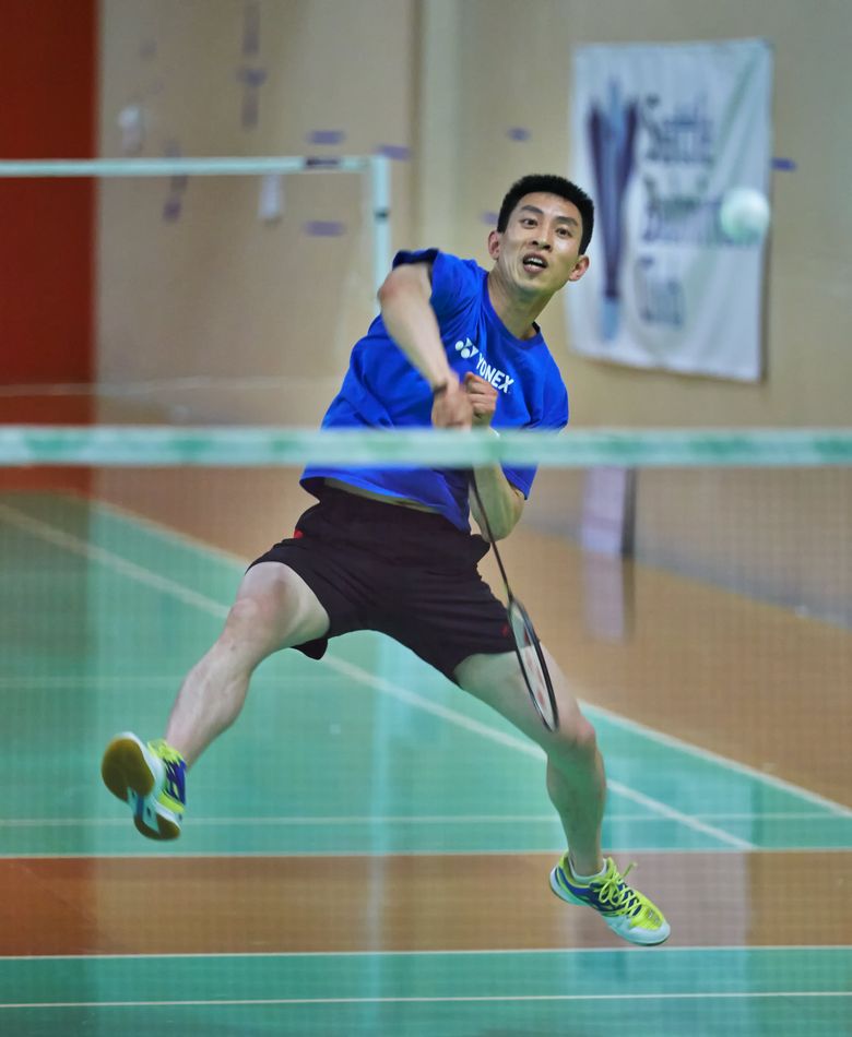 During a fast moving badminton match,Tao Yuan smashes against his opponent at the Seattle Badminton Club in Kirkland.