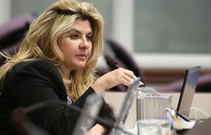FILE – In this June 3, 2013, file photo, Nevada Assemblywoman Michele Fiore, R-Las Vegas, works in committee during the final day of the 77th Legislative session at the Legislative Building in Carson City, Nev. Fiore, a friend of the Bundy family, was key in getting the final four occupiers of the Malheur National Wildlife Refuge in Oregon, to give up Thursday, Feb. 11, 2016. When she heard the FBI had surrounded the refuge, she called into an online talk show to try to calm down the occupiers. (AP Photo/Cathleen Allison, File)