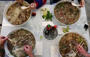 Clockwise from top left: Chas Roberts, Seattle Times writer Bethany Jean Clement, Miles James and Matt Tinder take the Pho Super Bowl Challenge at Dong Thap Noodles: the quest to eat a gigantic bowl of phoâ€”three liters of broth, four pounds of noodles, four pounds of meatâ€”within 90 minutes, Thurs., Jan. 28, 2016, in Seattle. All were beaten by the bowl, red-lined sodium levels and normal-sized stomachs too small for the task.