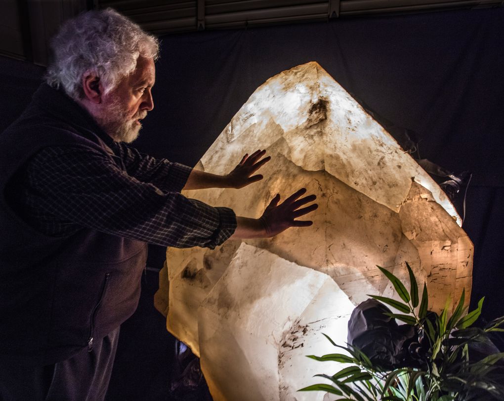 Richard Berger feels a 7,000-pound crystal from his collection of massive minerals. He hopes to keep it in the Northwest. (Steve Ringman / The Seattle Times)