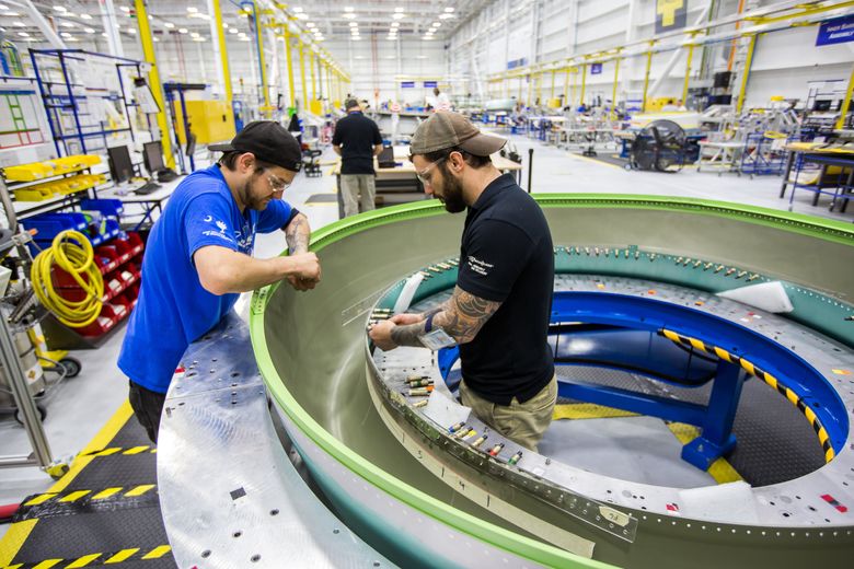 At Boeing South Carolina, a lip skin from supplier GKN is worked on by Boeing propulsion mechanics Kevin Tierney, left, and Larry Steel, who are assembling a 737 MAX nacelle inlet. (Mic Smith / Special to The Seattle Times)
