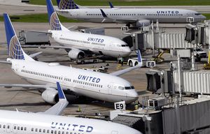 ADVANCE FOR WEDNESDAY, OCT. 14 AND THEREAFTER – FILE – In this July 8, 2015 file photo, United Airlines planes are parked at their gates as another plane, top, taxis past them at George Bush Intercontinental Airport in Houston. U.S. airlines have ramped up an aggressive lobbying campaign that seeks nothing less than converting the government from industry regulator to business ally. The big three legacy carriers, Delta, American and United, want the Obama administration to protect them from competition from foreign airlines, arguing those rivals can undercut ticket prices thanks to government subsidies or cheaper labor. (AP Photo/David J. Phillip, File)