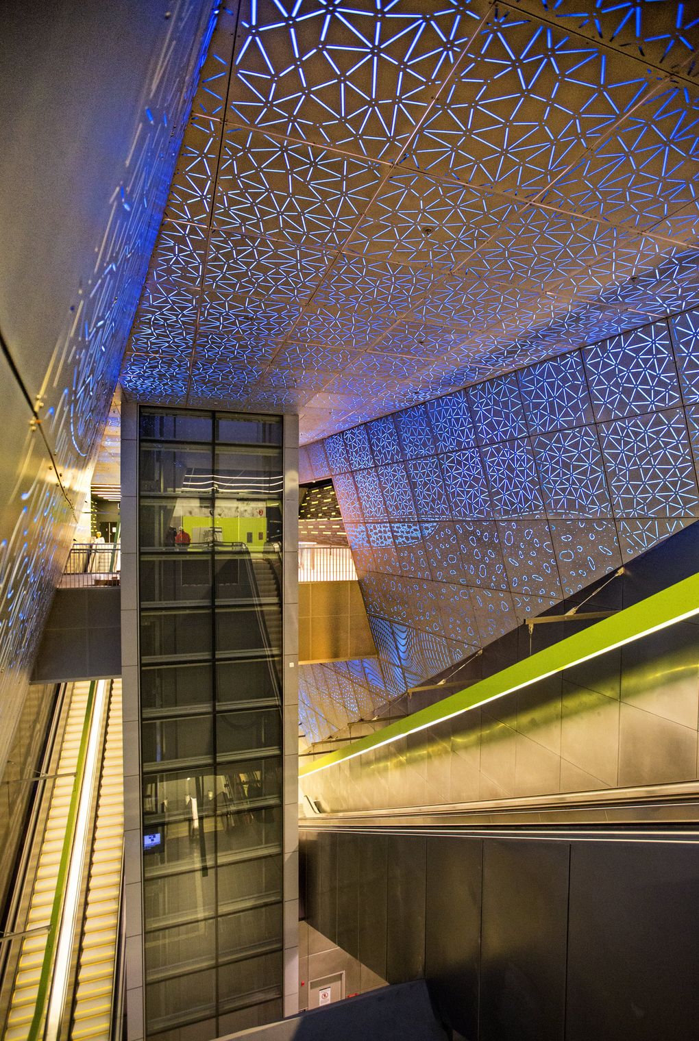 University of Washington graduate Leo Saul Berk created “Subterranium,” artwork that surrounds escalators and an elevator inside the station. His concept, employing a hatch pattern in the backlit metal walls, represents the geologic layers encountered as the station was excavated. (Mike Siegel / The Seattle Times)