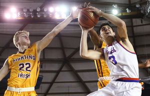 Rainer Beach forward Sam Cunliffe drives to the basket against O’Dea wing Race Porter, left and O’Dea guard Noah Williams, back in the 3A Boys title game during the Hardwood Classic tournament at the Tacoma Dome on Saturday, March 5, 2016.
