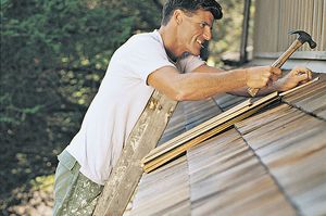If you choose to fix loose or missing roof shingles yourself, be sure it’s done safely. (Thinkstock)