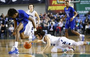 Federal Way’s Jalen McDaniels tries to locate the loose ball on the ground as Gonzaga Prep’s Bryan Cooper puts out a hand to grab it in a 4A Boys semifinal game during the Hardwood Classic tournament at the Tacoma Dome on Friday, March 4, 2016. The Hardwood Classic concludes with the state title games on Saturday.