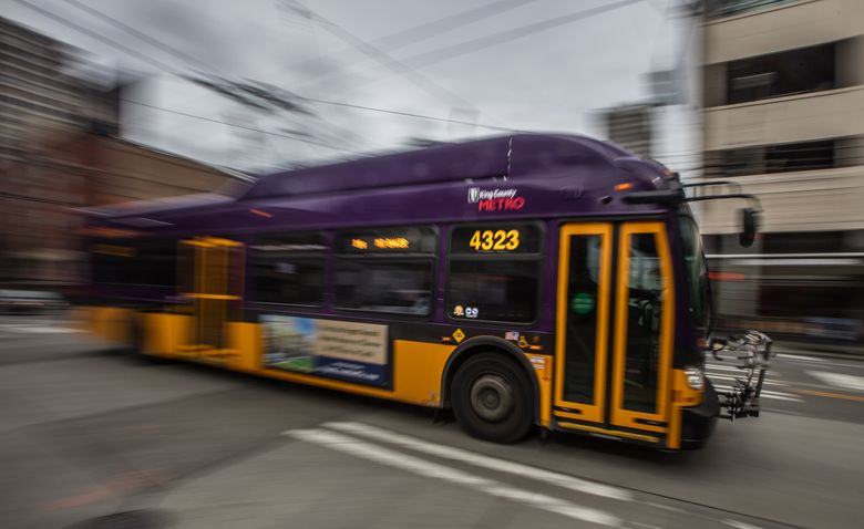 An all-electric Metro Transit bus cruises Third Avenue in downtown Seattle. Mayor Ed Murray hopes to cut Seattle greenhouse-gas pollution in half by 2025, partly with more electric vehicles in the city’s fleet.  (Steve Ringman/The Seattle Times)