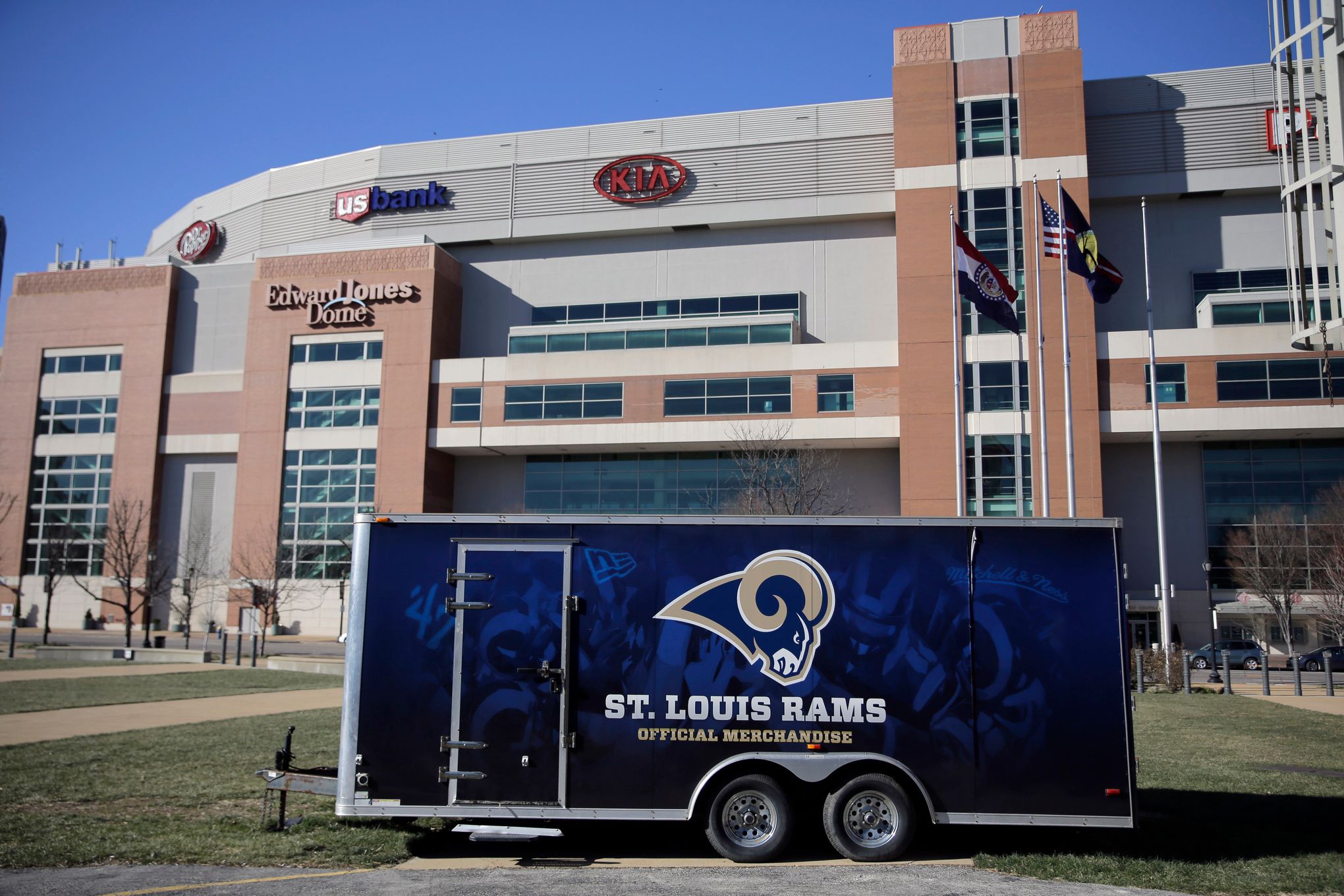 Workers removing Rams banners from the Edward Jones Dome