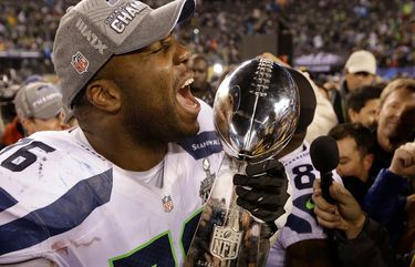 Seahawks offensive tackle Russell Okung (76) holds the Lombardi Trophy after the Seahawks beat the Denver Broncos 43-8 in Super Bowl XLVIII at MetLife Stadium in East Rutherford, New Jersey on Sunday, February 2, 2014.
Photo made at 7:22.16 EST.
SEATTLE SEAHAWKS – DENVER BRONCOS – NFL – SUPER BOWL XLVIII – SEATTLE TIMES – 135797 – 135984 – 135985 – 135986 – 136009 – 3.0.2167479100#Sports#Sports#20140203#3.0.2167479118