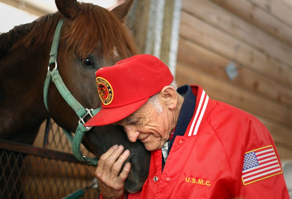 Don Munger, a longtime trainer at Emerald Downs, snuggles up to Boise Creek, a 2-year-old colt, on Aug. 4, 2009. (John Lok / The Seattle Times)