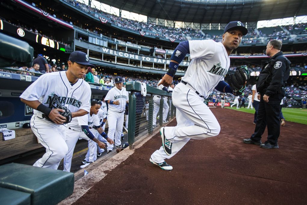 Robinson Cano leads the Mariners onto the field to play Oakland on April 9 in Seattle. (Dean Rutz / The Seattle Times)