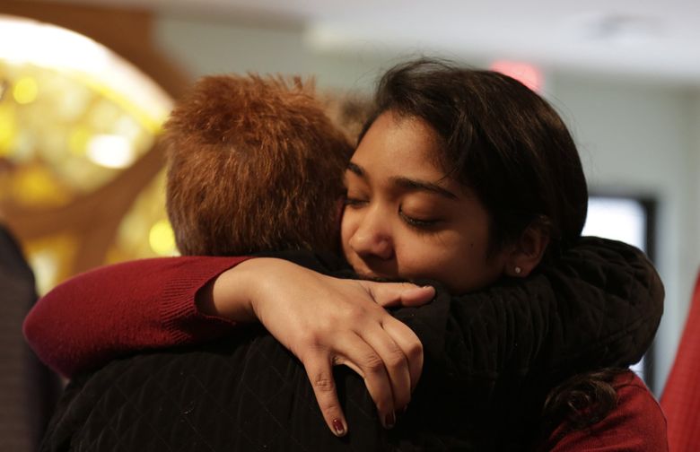 Nikita Deep, 16, embraces a family friend at Antigo United Methodist Church following a morning service Sunday, April 24, 2016, in Antigo, Wis. According to police Jakob E. Wagner, 18, opened fire with a high-powered rifle outside of the a prom at Antigo High School late Saturday. Deep is class president at the school and was involved in the coordination of the prom.  (Jacob Byk/The Marshfield News-Herald via AP) 