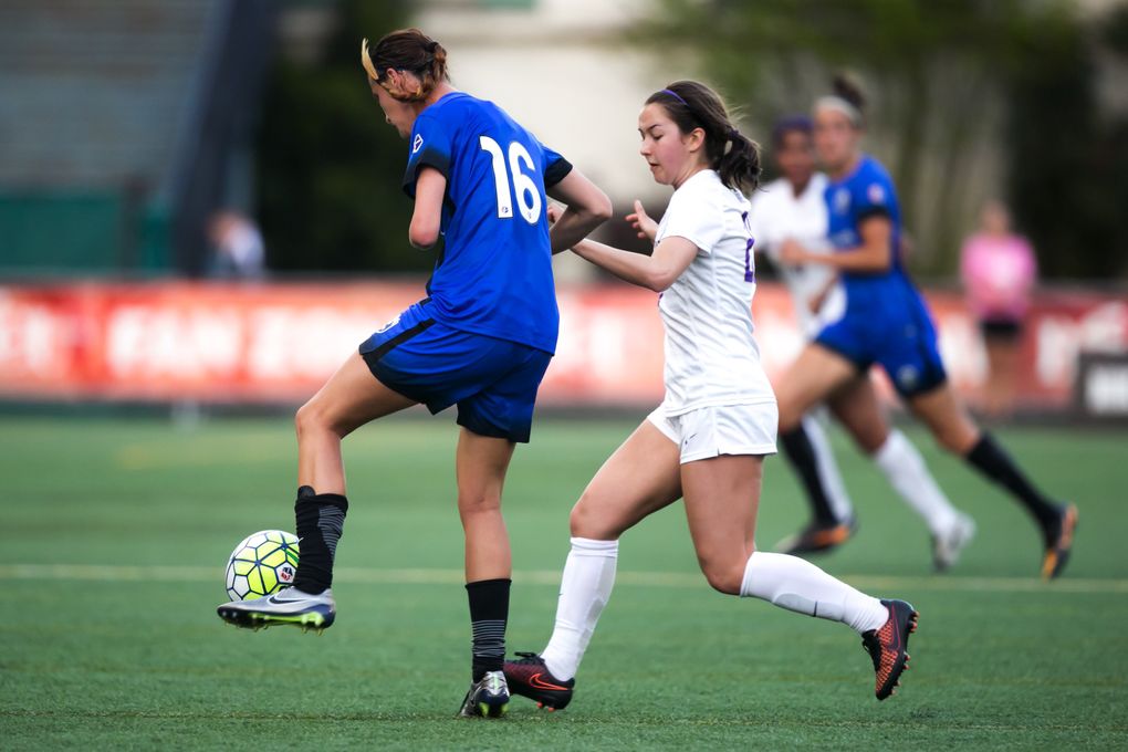 Reign defender Carson Pickett controls the ball around UW’ forward/midfielder Miranda Rawlings during a preseason friendly on April 9, 2016. (Bettina Hansen/The Seattle Times)