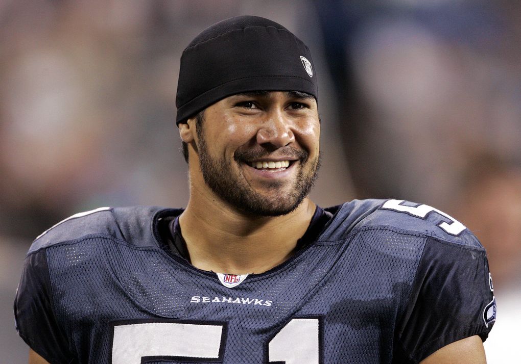 Seahawks linebacker Lofa Tatupu smiles from the sidelines during a preseason game against the Dallas Cowboys on Aug. 12, 2006, in Seattle. (Elaine Thompson / AP)