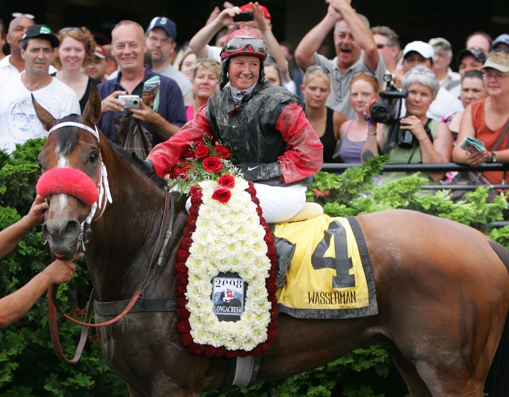 Wasserman (4), ridden by Jennifer Whitaker, celebrates in the winner’s circle after coming from the outside to catch favored True Metropolitan (11) and Tropic Storm (2) at the wire in the Longacres Mile at Emerald Downs on Aug. 17, 2008. (Jim Bates / The Seattle Times)