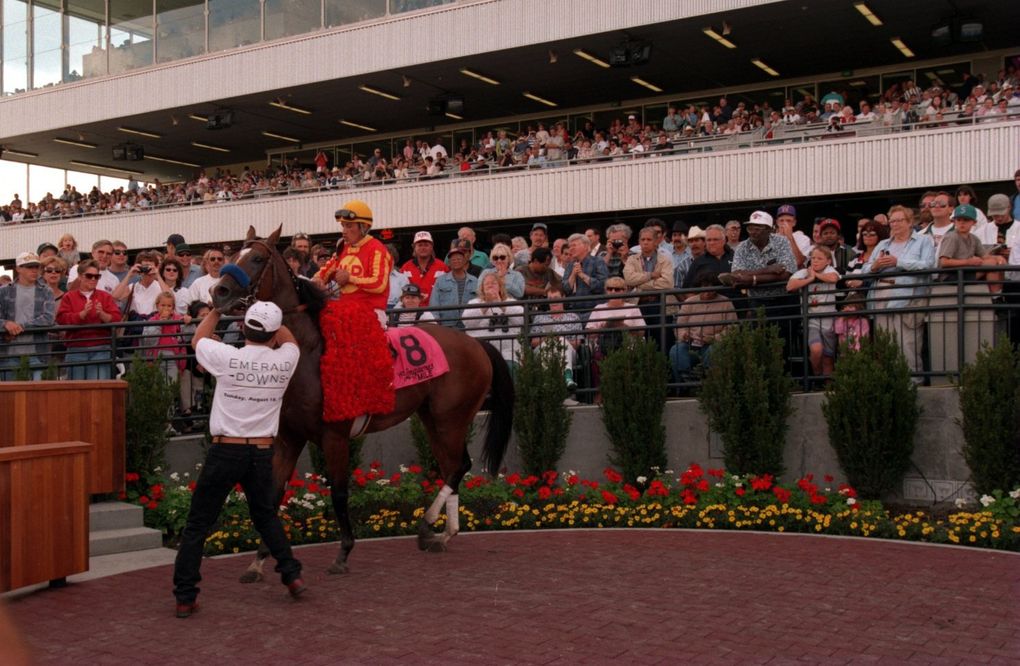 Jockey David Flores rides Isitingood into the winner’s circle of Emerald Downs after winning the Longacres Mile on Aug. 18, 1996. (Teresa Tamura / The Seattle Times)