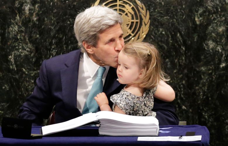 U.S. Secretary of State John Kerry kisses his granddaughter (name?) after signing the Paris Agreement on climate change, Friday, April 22, 2016 at U.N. headquarters. (AP Photo/Mark Lennihan)