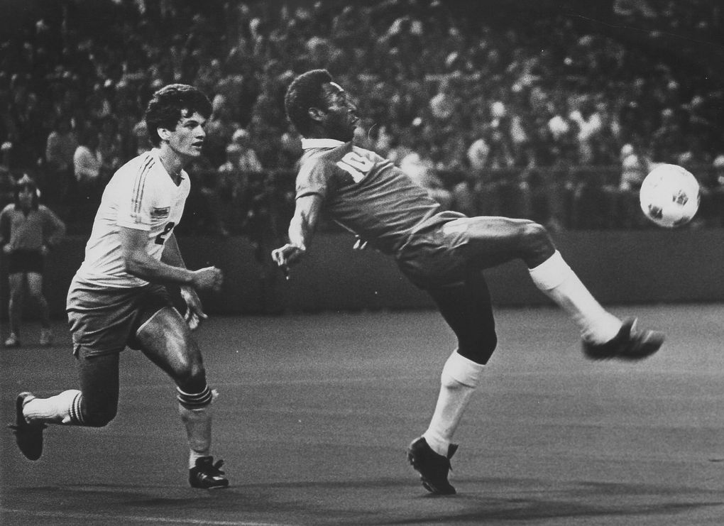 Pele put his world-famous toe to the ball during a 1976 exhibition match against the Sounders at the Kingdome. Following the ball was Seattle’s Dave D’Errico. (Seattle Times file)