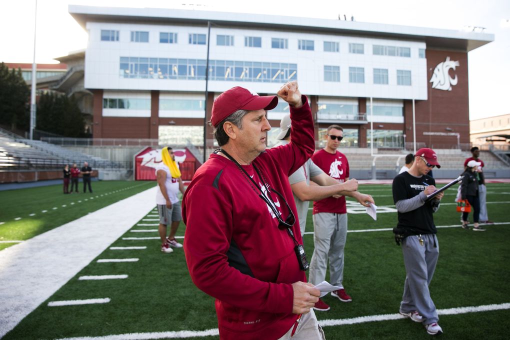 Football coach Mike Leach works during practice at Washington State. (Erika Schultz/The Seattle Times)