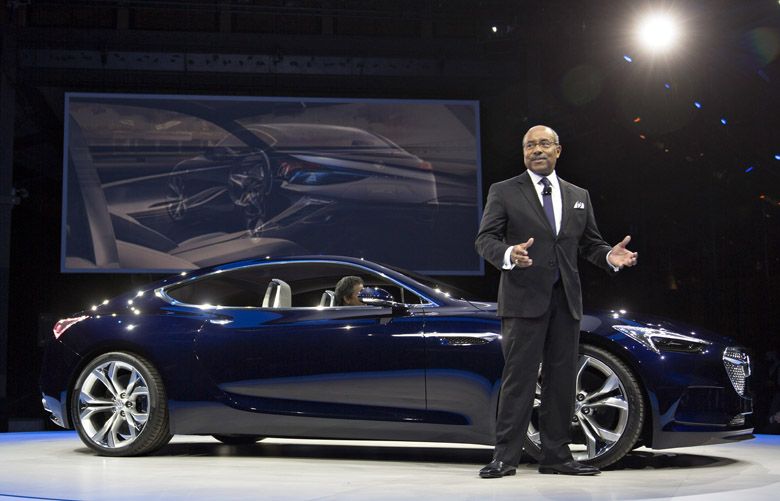 Edward “Ed” Welburn, vice president of global design at General Motors Co. (GM), speaks next to a General Motors Co. Buick Avista concept vehicle during an event ahead of the 2016 North American Auto Show (NAIAS) in Detroit, Michigan, U.S., on Sunday, Jan. 10, 2016. General Motors Co. is making its latest play to bring Buick back in the U.S. by showing off the Avista sporty coupe concept and the Chinese-built Envision sport utility vehicle today in advance of the Detroit auto show. Photographer: Andrew Harrer/Bloomberg *** Local Caption *** Ed Welburn