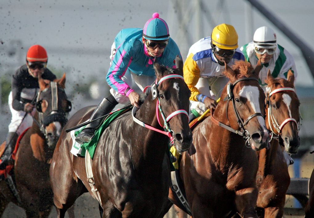 Jockey Ricky Frazier pulls out in front before the first turn during the Longacres Mile aboard 4-year-old Noosa Beach, owned by Jeff and Doris Harwood, at Emerald Downs on Aug. 22, 2010. It was the 75th running of the Longacres Mile. (Ellen M. Banner / The Seattle Times)