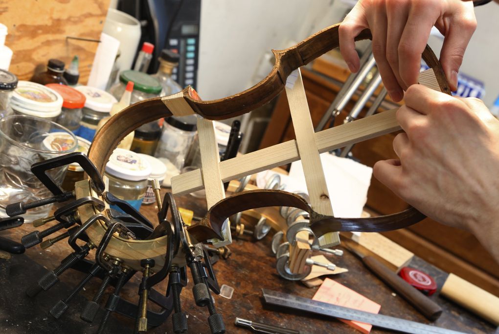 A member of Rafael Carrabba’s local team, which restores rare and valuable instruments on Seattle’s Queen Anne Hill, works on a violin made around 1800. (Ken Lambert/The Seattle Times)