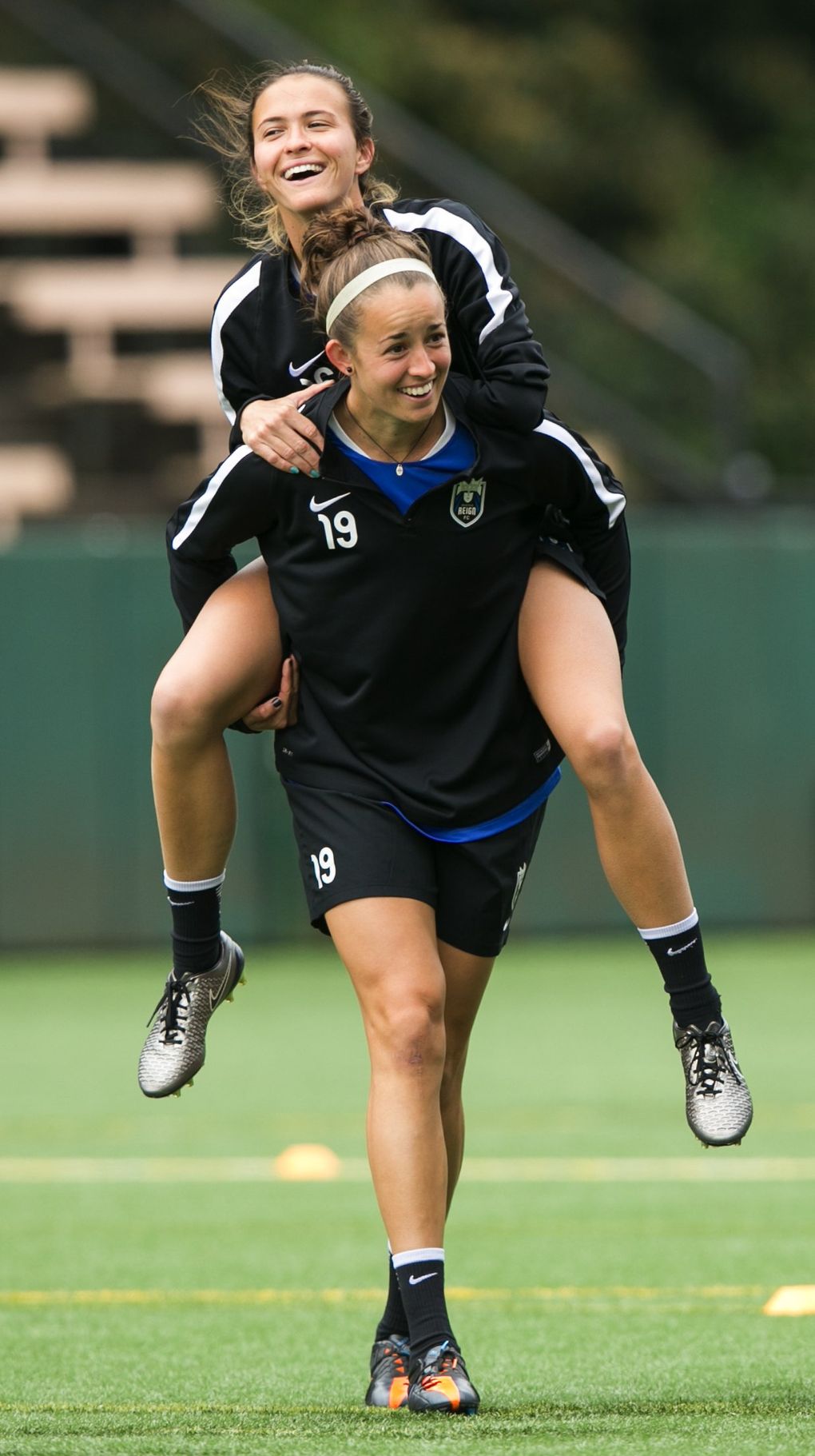 Seattle Reign defender Carson Pickett piggybacks on midfielder Havana Solaun during a fun drill at practice April 11, 2016. Pickett and Solaun are good friends — the two met while playing tennis as kids in Florida. (Bettina Hansen/The Seattle Times)