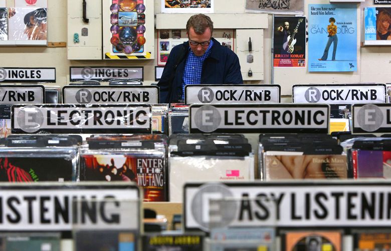 Robert Lots, a Toronto resident who is in town for work, sorts through some of the thousands of records on display at Everyday Music on Capitol Hill, Tuesday, April 12, 2016.